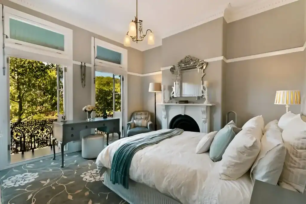 Bright bedroom with large windows and elegant decor, perfect for a cozy, stylish space.