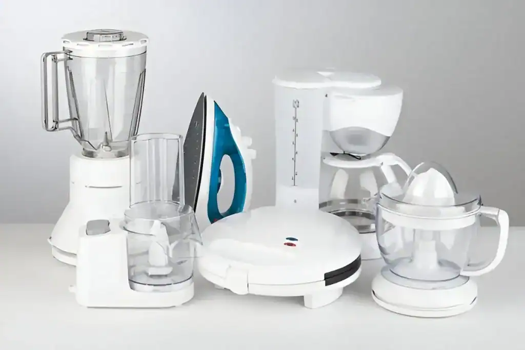Blender, iron, coffee maker, and food processor on white background.
