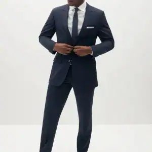 Elegant men's navy blue suit with tie, perfect for weddings and special events.